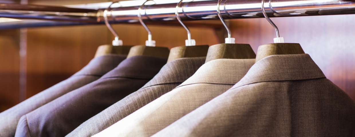 closeup of mens suits hanging up, multicolored suits