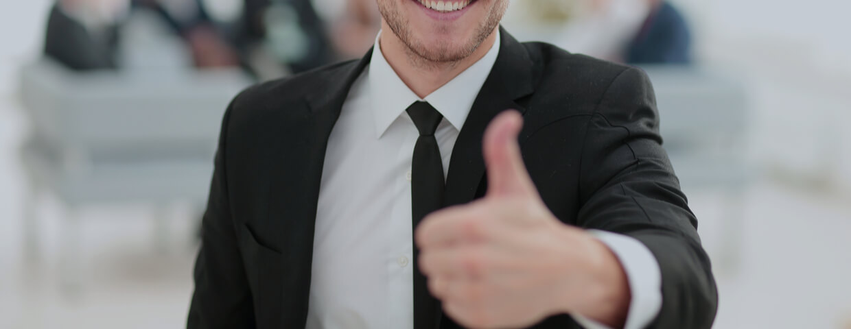young adult male, wearing suit, very happy, giving thumbs up gesture