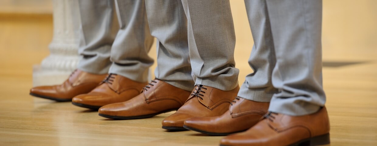 closeup of men in light grey dress slacks and dress shoes